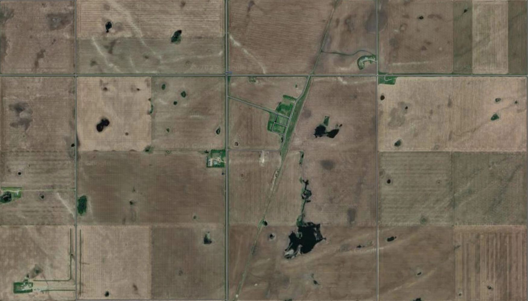 Stack of books next to pencils in a holder and a camera.