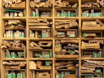 Wooden shelves filled with organized, labeled packages and tubes.