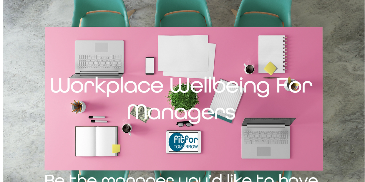 Pink office desk with computers and note pads ready for a managers training session