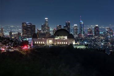Nighttime view of the Griffith Observatory with the Los Angeles skyline in the background
