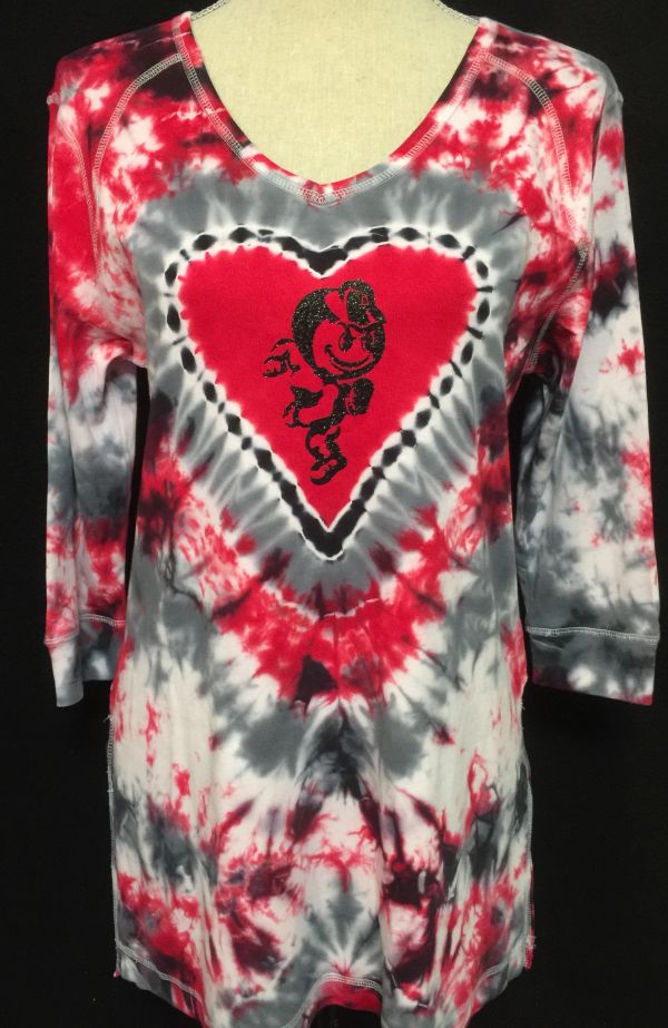 Tie-dye shirt with red, black, and white colors featuring a heart and cartoon character.