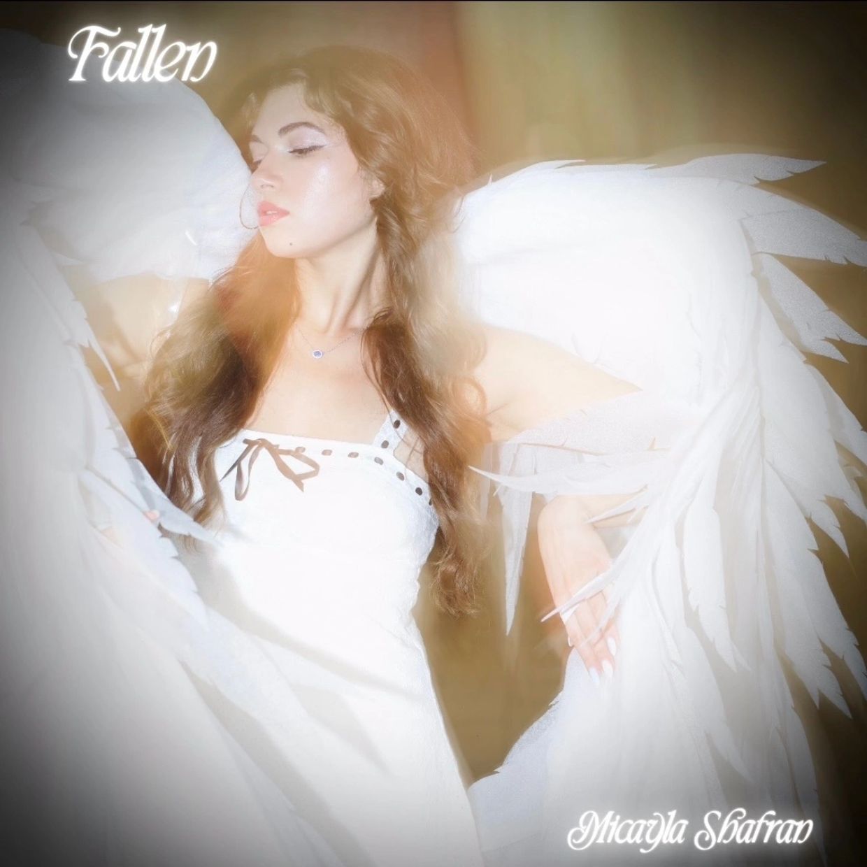 A woman with angel wings and soft lighting, titled 'Fallen'.