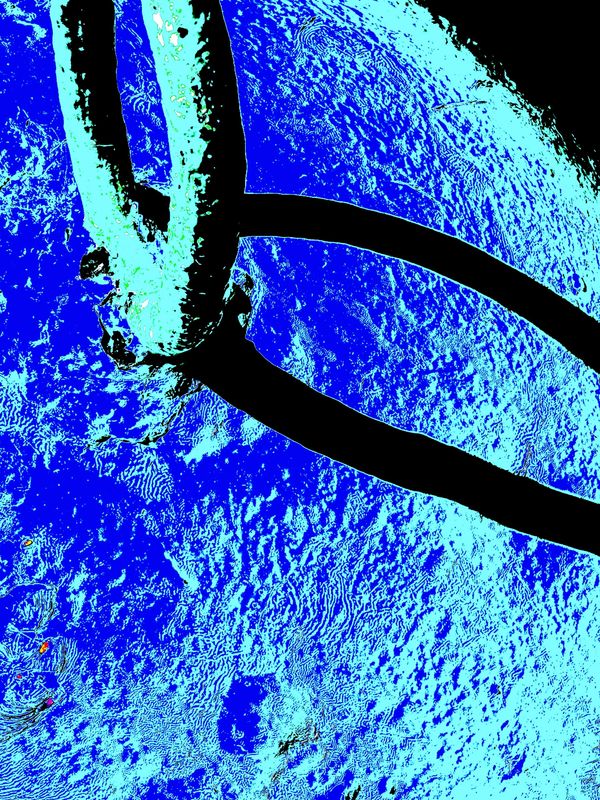 Close-up of a trident on a textured blue surface.