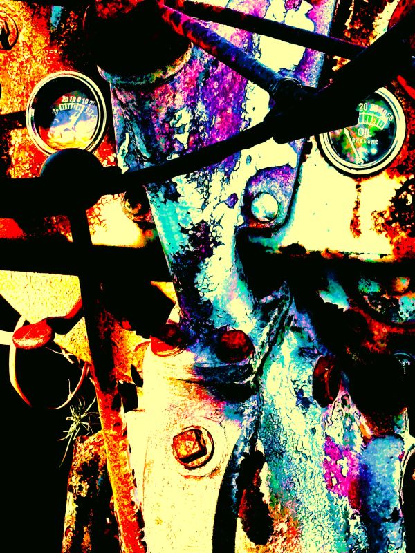 Close-up of a colorful, weathered machine dashboard with gauges and levers.