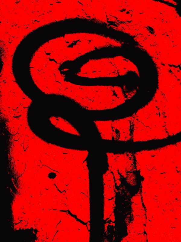 Black graffiti on a cracked red wall forming a spiral shape.