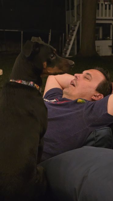 Man and dog sharing a quiet moment outdoors.