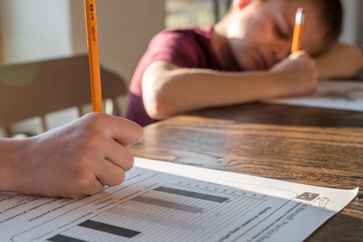 Two children doing homework at a table