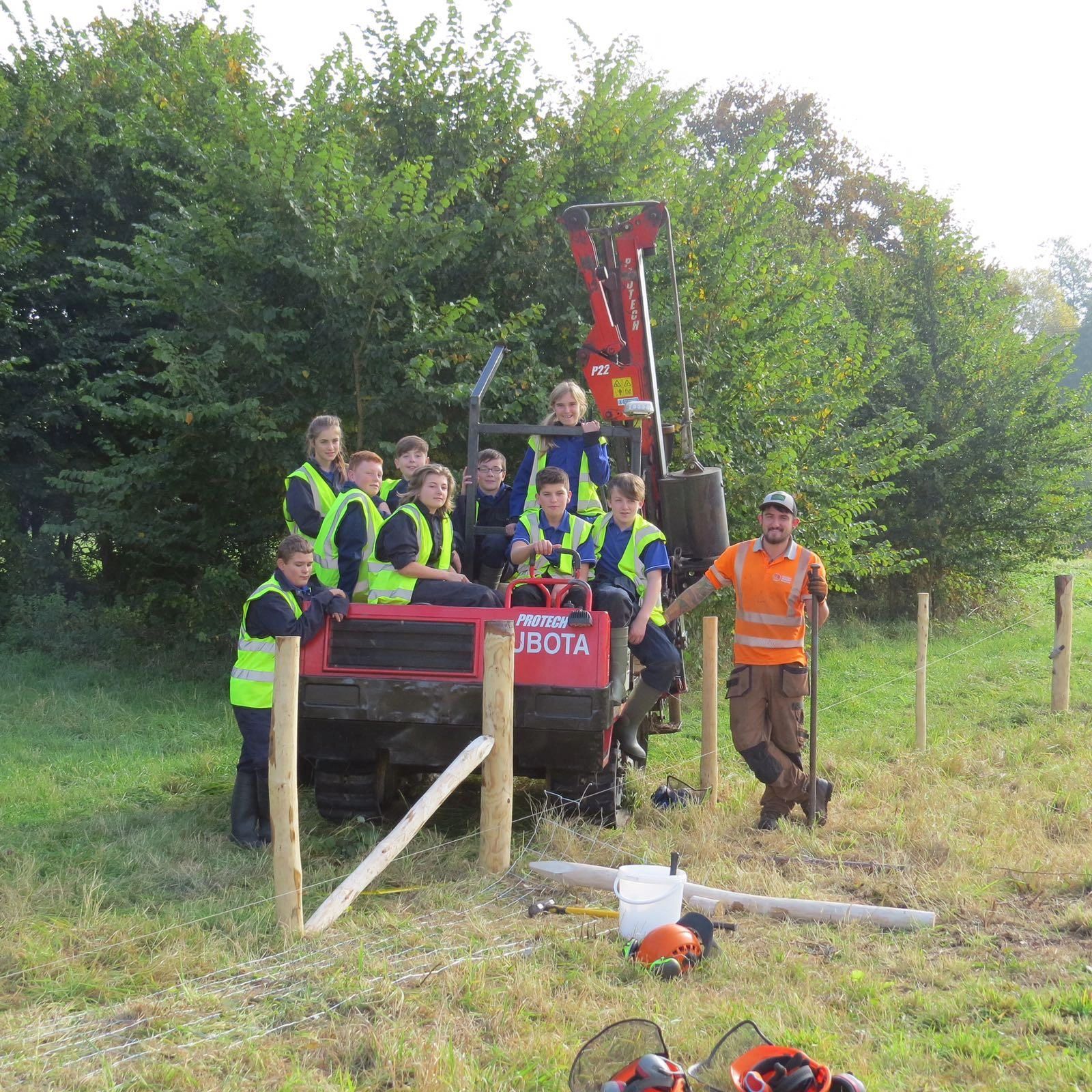 One of the Knighton team teaching students from Dorset Studio School how to construct a fence.
