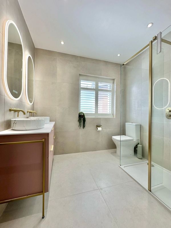 Modern bathroom with elegant lighting and a glass shower enclosure.