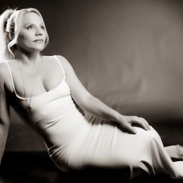 KASEY BALL in a gown is sitting on a floor 
