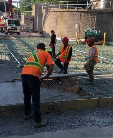 Workers pouring concrete