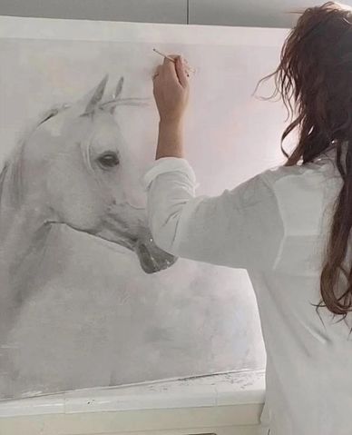 Artist painting a realistic white horse portrait in grayscale.
