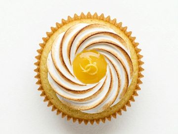 A lemon meringue tart with a swirl of toasted meringue and lemon curd center.