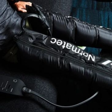 man in compression boot therapy session
