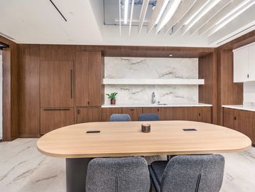 Modern office meeting room with wood paneling and marble accents.