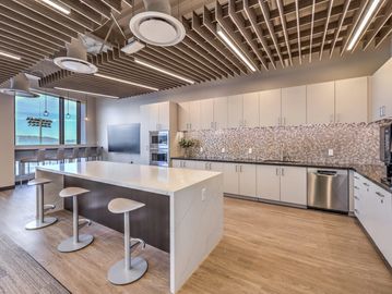 Modern kitchen with island and stools.