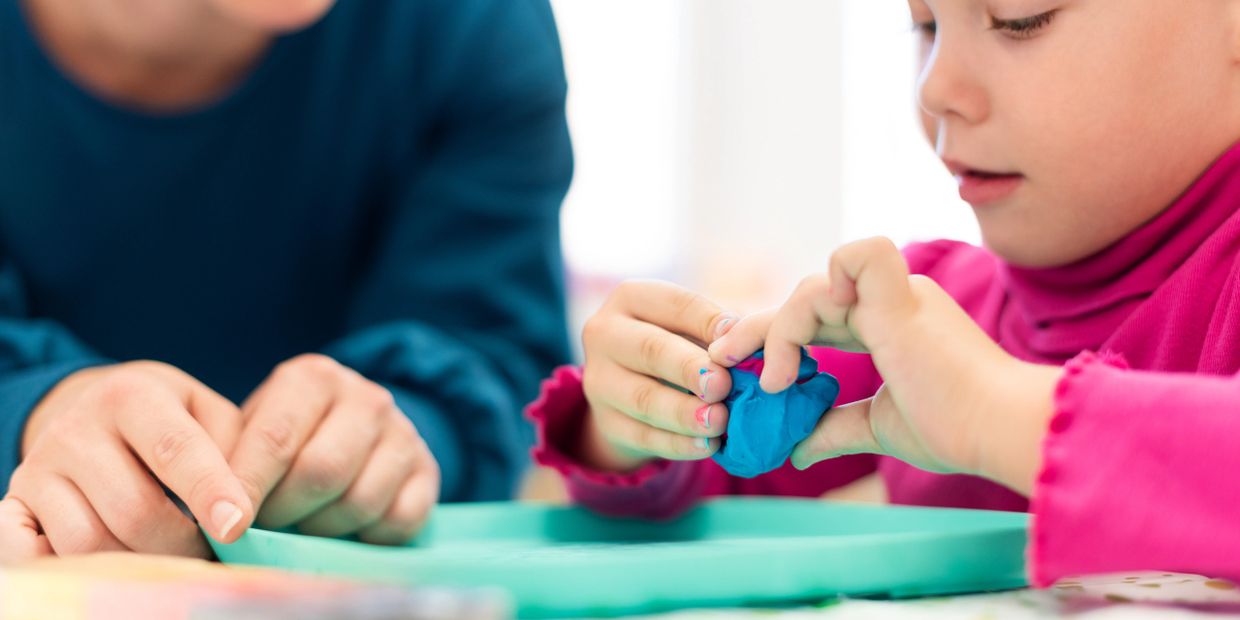 picture of a child in Play Therapy with a clinician.