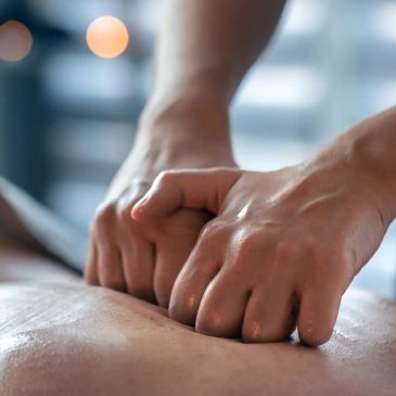 Close-up of hands giving a deep tissue massage.