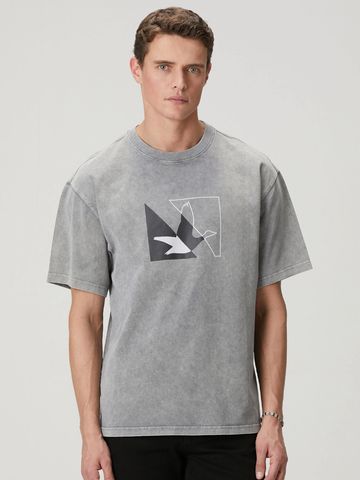 Man wearing a gray graphic t-shirt with a bird design.