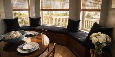 Cozy dining corner with cushioned bench and table setting.