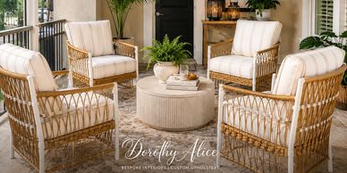 Cozy outdoor seating area with wicker chairs and a round table.