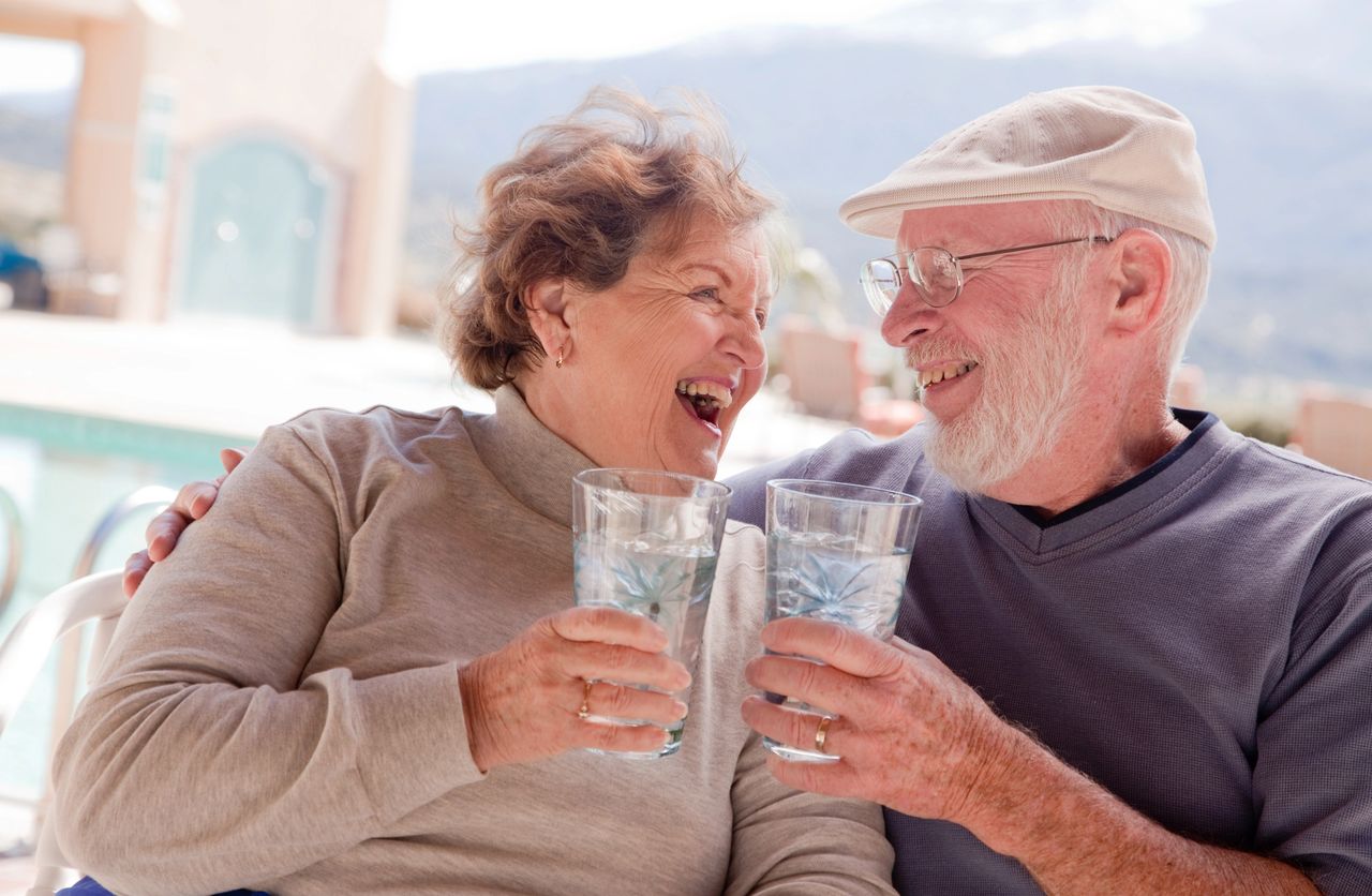 Elderly Couple enjoying a drink a water. Elderly Couple enjoying a drink a water.