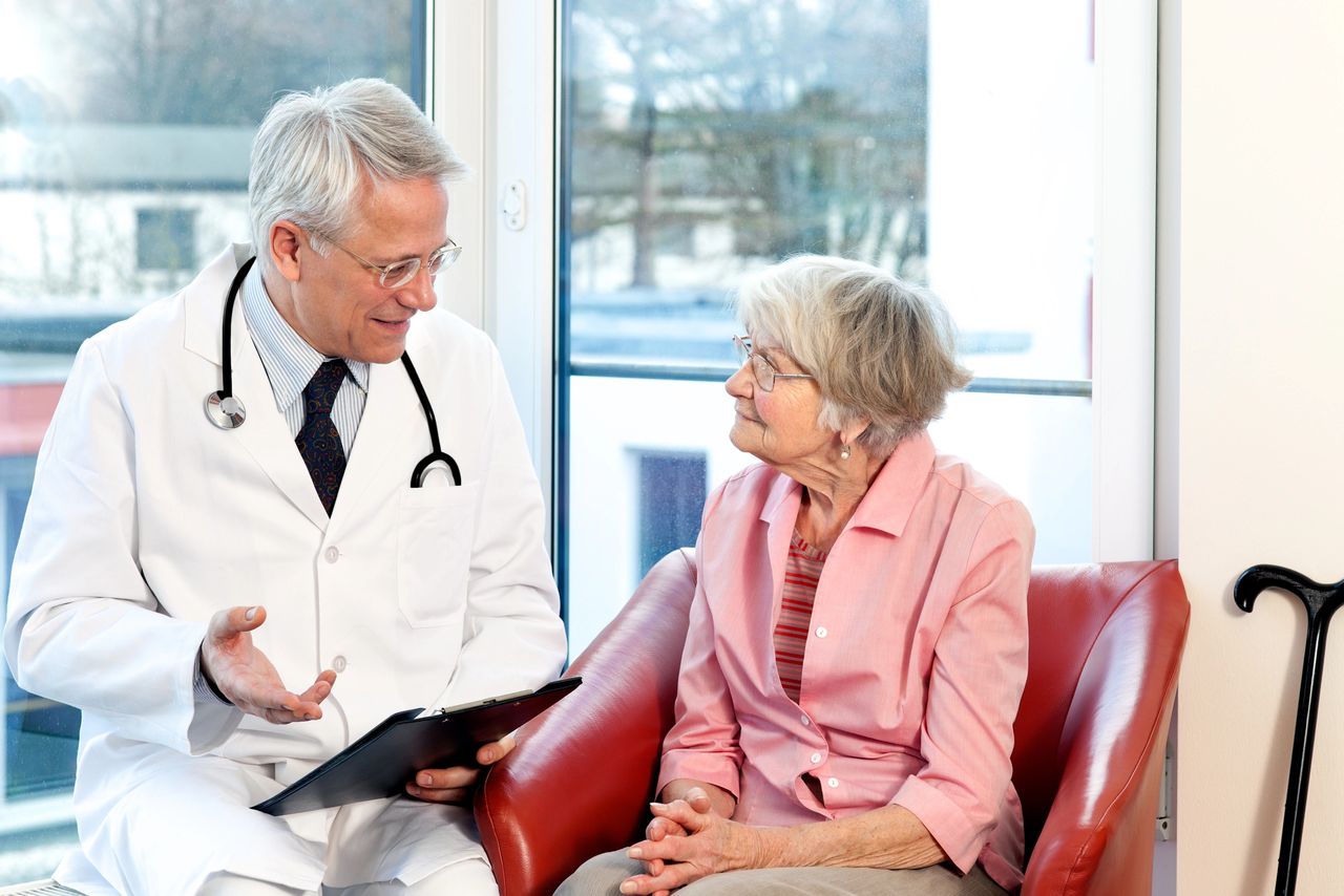 Geriatric doctor talking to elderly patient Geriatric doctor talking to elderly patient