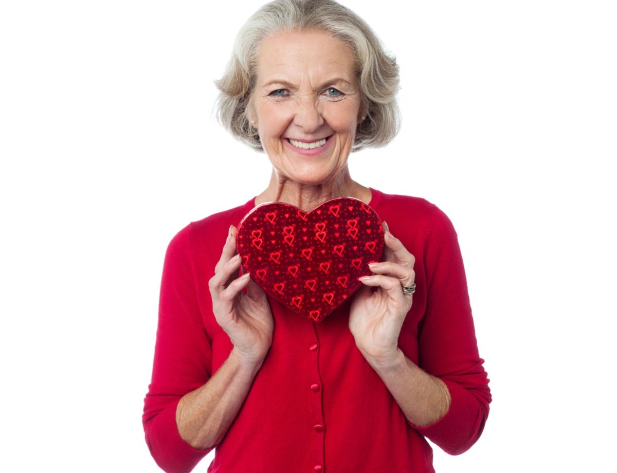 Smiling Elderly Woman Holding Valentine Candy Box Smiling Elderly Woman Holding Valentine Candy Box