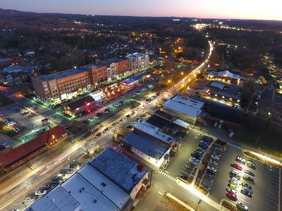 Downtown Woodstock, GA at night lit up with lights.