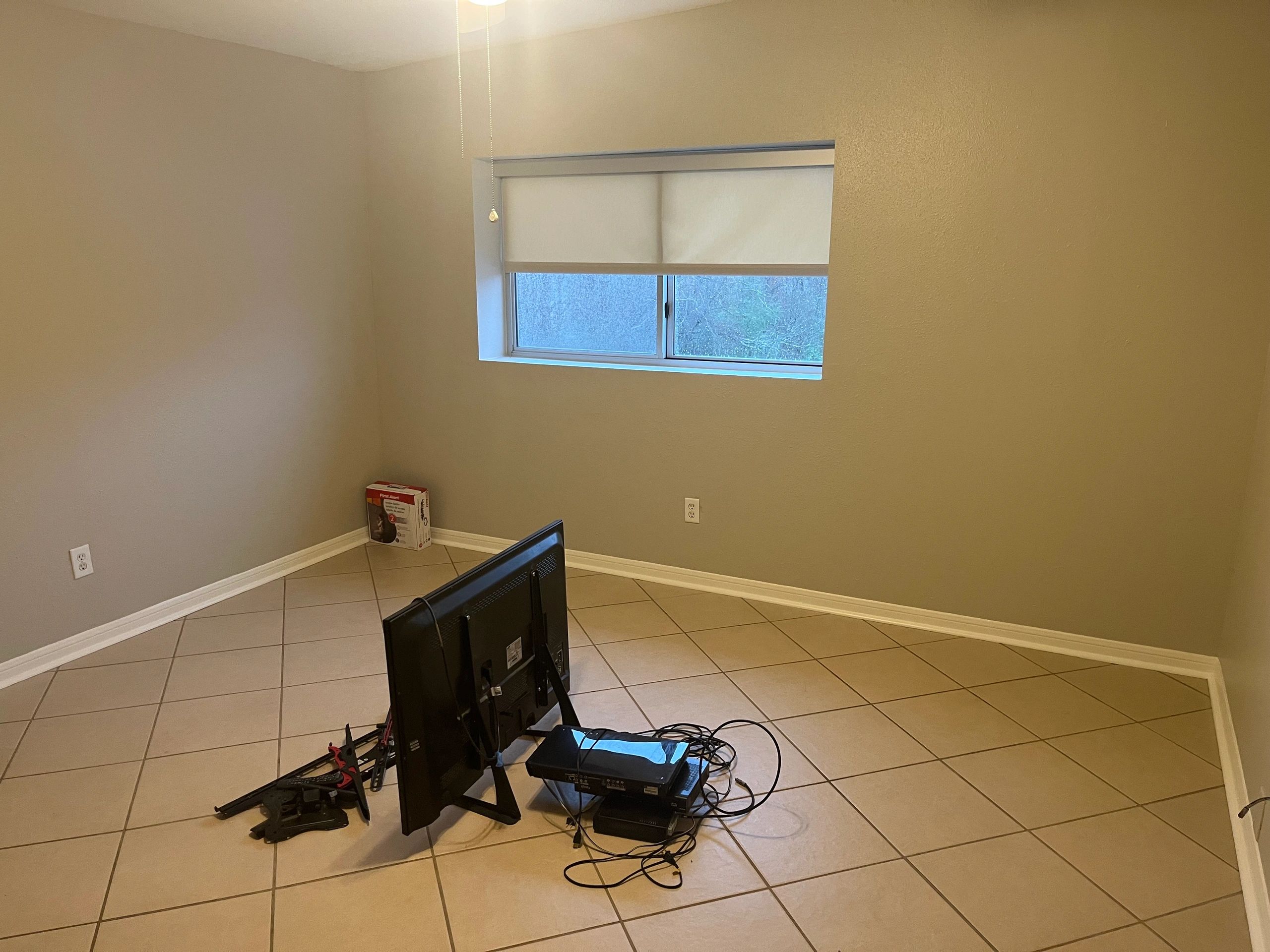 Empty room with electronic devices on the floor.