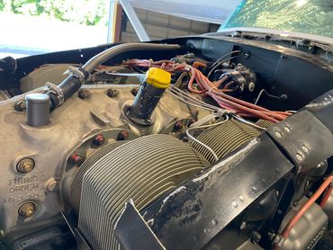 Close-up of a car engine with visible components and wiring.