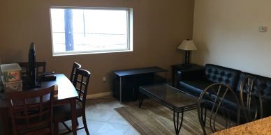 Small living area with table, chairs, and sofa.