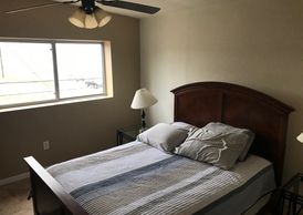 Simple bedroom with wooden bed and window.
