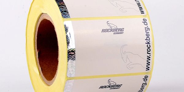 Roll of Rockberg Germany branded adhesive labels with website URL.