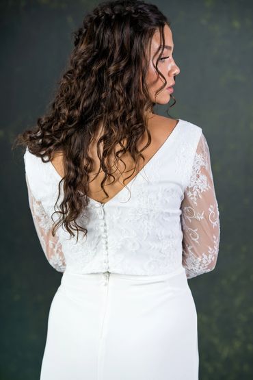 ivory lace top with 3/4 length sleeves and v shape back. covered buttons on the back.