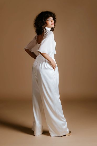 Luxury bridal jumpsuit with an open back detail, floaty sleeves and wide leg pants.