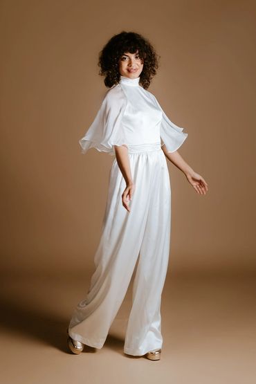 Modest bridal jumpsuit with delicate sheer sleeves and wide leg trouser.