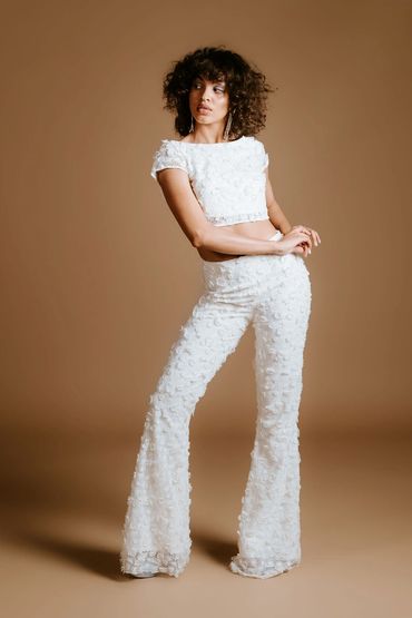 Unique wedding outfits for the modern bride.
Crop top and flared trousers made in 3D floral lace.