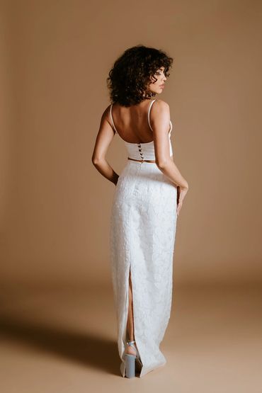 Bridal bralette with thin shoulder straps and a matching floor length skirt with a back slit.