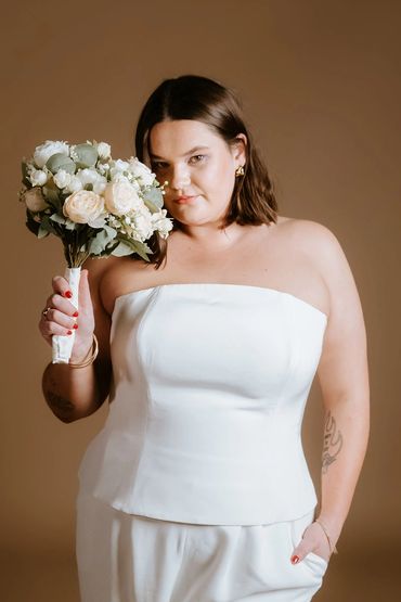 Sleek and structured bridal top secured with invisible zip in ivory. Harrison Bustier