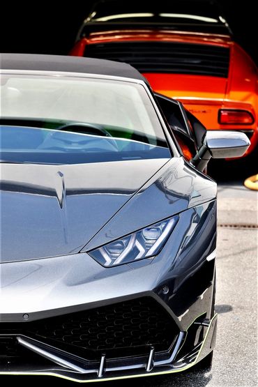Lamborghini Huracan with a Lamborghini Miura in the background. 