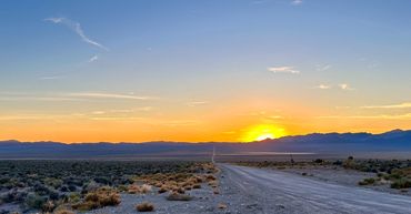 Sunset over Groom Lake Road in Nevada. Area 51 lies beneath the sunset.