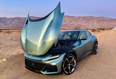 Ferrari Purosangue with huge clamshell open outside Clark Dry Lake Borrego Springs California.