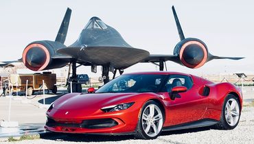 Ferrari 296 GTB in Rosso Imola flanking a Lockheed A12  at the Blackbird Airpark in Palmdale.