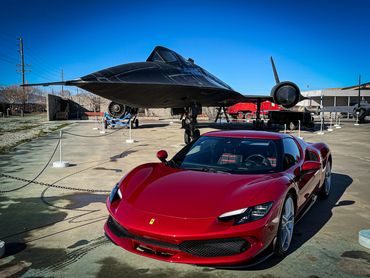 Ferrari 296 GTB in parked in front Lockheed’s most famous spy planes the SR71 Blackbird. Palmdale.