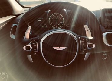 Aston Martin Vantage steering wheel and dashboard. 