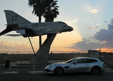 Ferrari GTC4 Lusso T  beneath a McDonnell Douglas F-4 Phantom located at Point Mugu Missile Park.