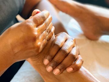 A foot being massaged with two hands