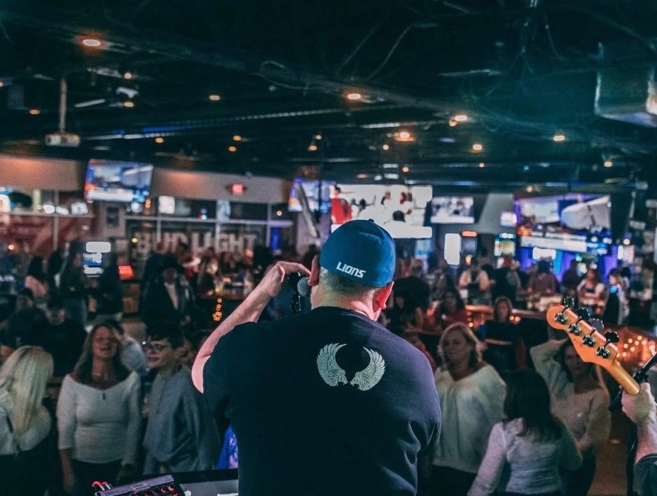 A lively crowd watching a band perform at That Place Bar & Grill