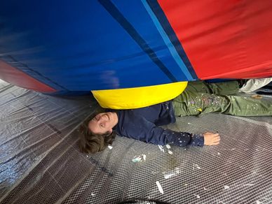 Riley Satterfield smiling underneath the Mario balloon.